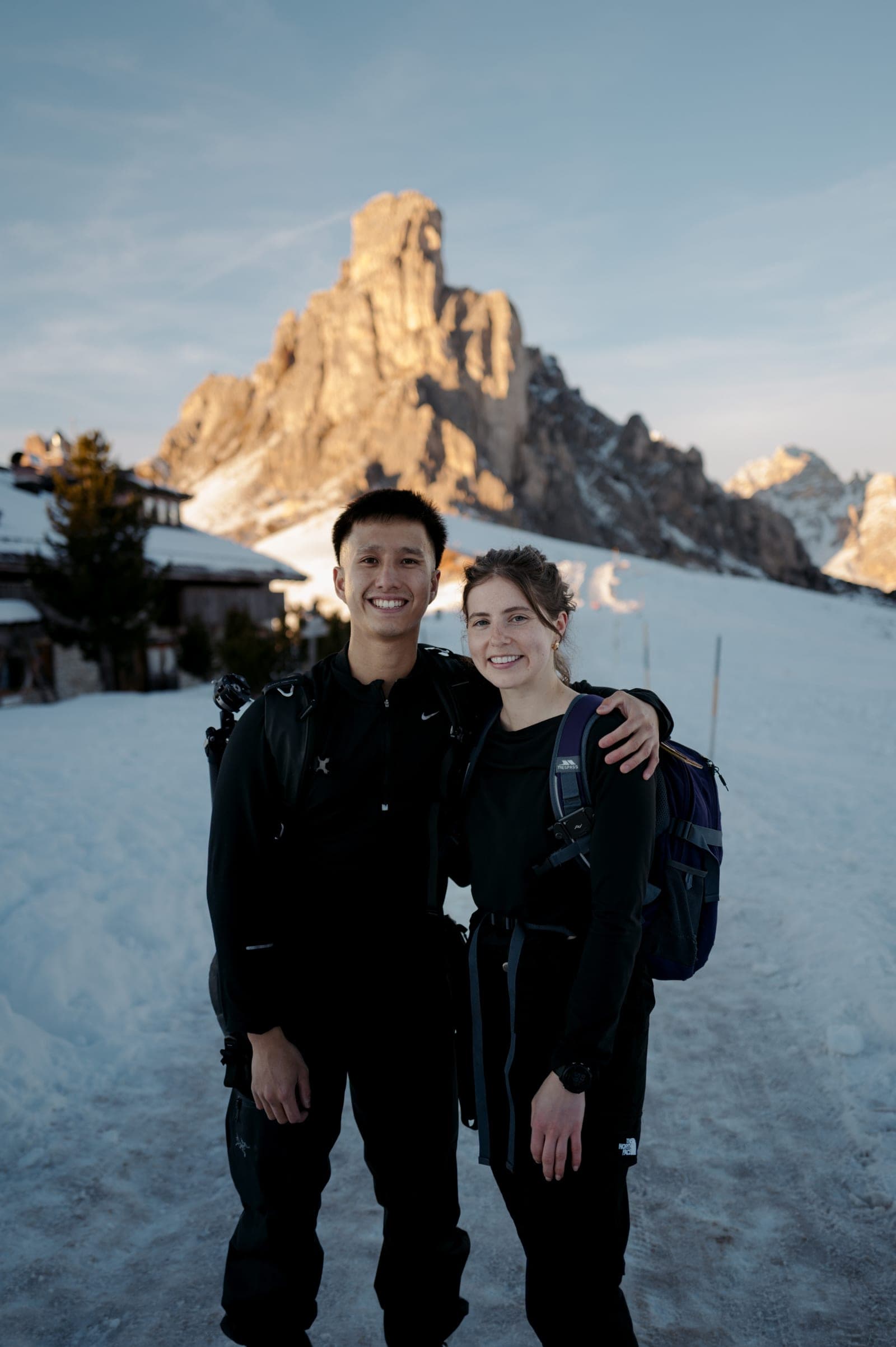 Claire and Martin in the snow beneath the peaks of the Dolomites