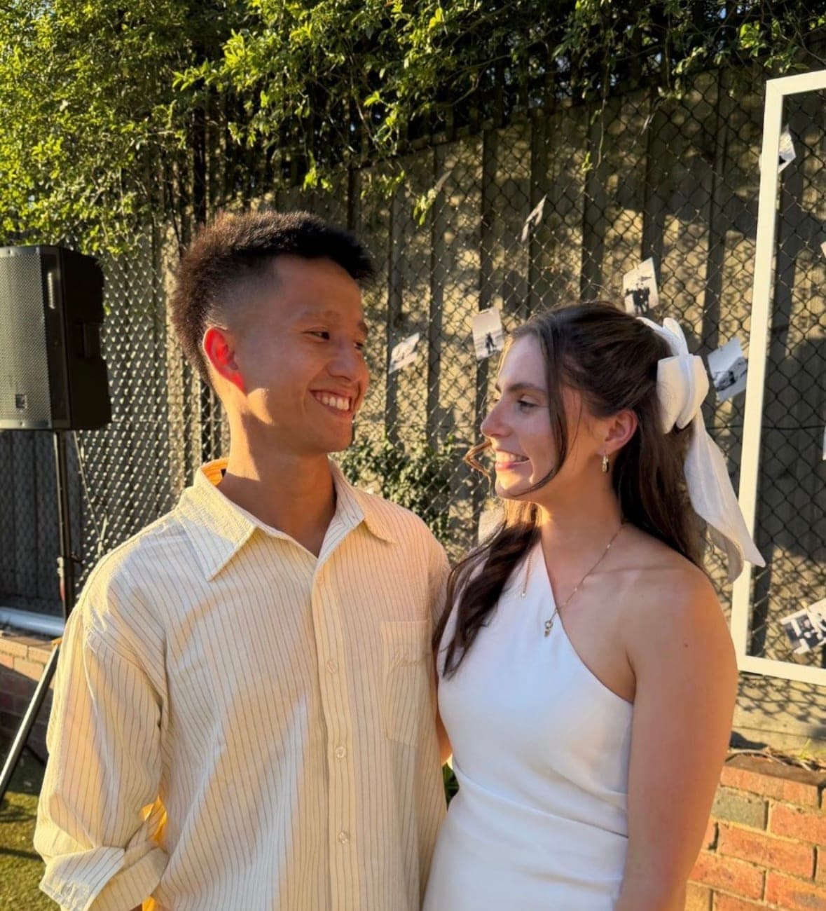 Claire and Martin smiling at each other outdoors in the sunshine